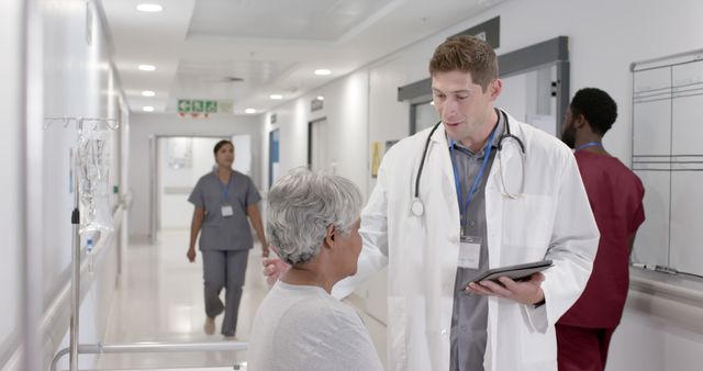 Doctor Consulting Elderly Patient in Hospital Corridor - Download Free Stock Images Pikwizard.com