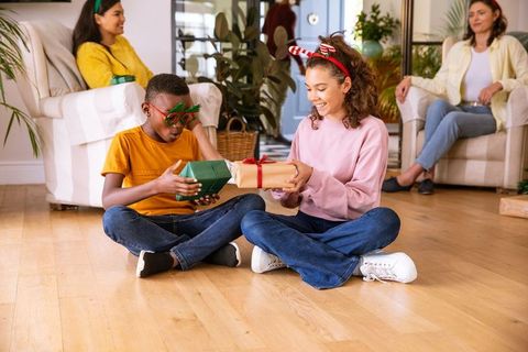 Children Exchanging Gifts in Cozy Family Setting During Holiday Celebration