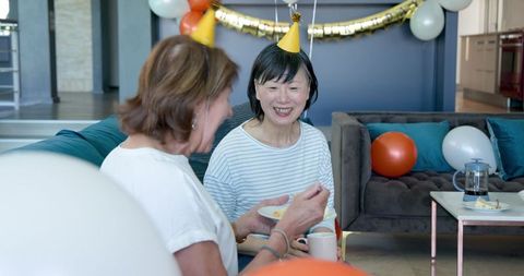 Senior Women Enjoying Cake at Birthday Celebration