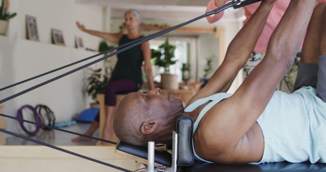 Senior Man Exercising on Pilates Reformer Machine in Fitness Studio - Download Free Stock Images Pikwizard.com