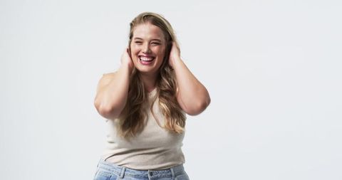 Joyful Plus Size Woman with Long Blonde Hair Laughing