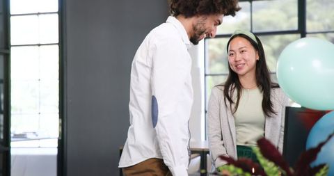 Diverse Team Celebrating Office Birthday with Cake and Balloons