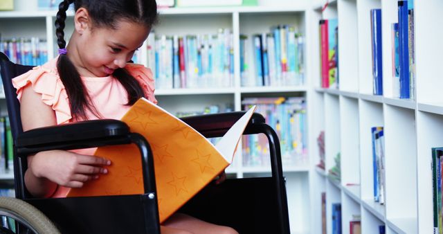 Young Girl in Wheelchair Reading Book in Library - Download Free Stock Images Pikwizard.com