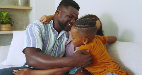 Happy Playful Family Hugging on Cozy Living Room Sofa