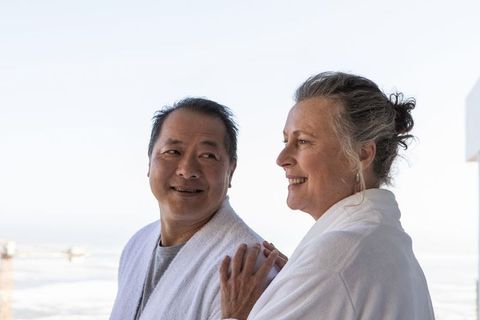 Senior Couple Relaxing on Balcony Overlooking Serene Seascape