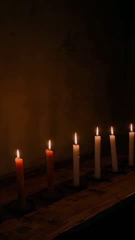 Flickering Taper Candles Dripping Wax on Metal Holders Along Rustic Ledge — Vertical Video