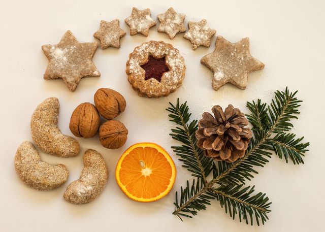 Rustic Holiday Arrangement with Cookies, Pinecone, and Orange Slice on White Background - Download Free Stock Photos Pikwizard.com