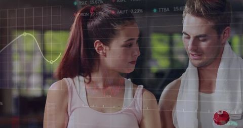 Workout Partners Analyzing Performance Data at Gym