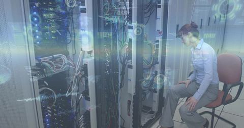 IT technician inspecting server rack with digital diagnostics overlay in datacenter