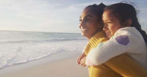 Joyful Mother and Daughter Enjoying Beach Sunset Together