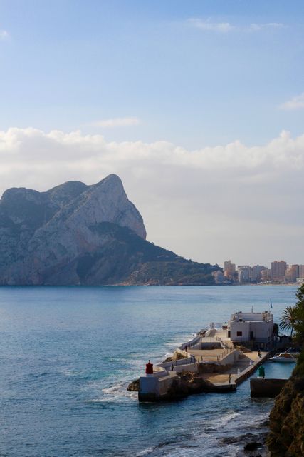 Scenic Mediterranean Coastal View with Cliff and Lighthouse Under Blue Sky - Download Free Stock Images Pikwizard.com