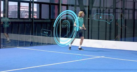 Paddle tennis player moving on blue indoor court with ar holograms and motion reflections