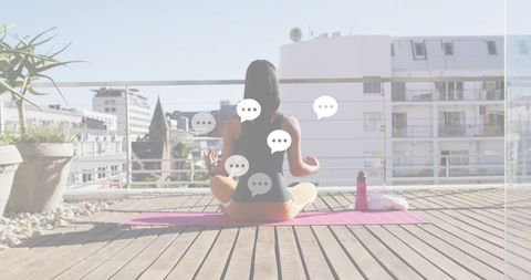 Urban Rooftop Yoga Woman Meditating on Pink Mat in Sunlit City Terrace for Wellness