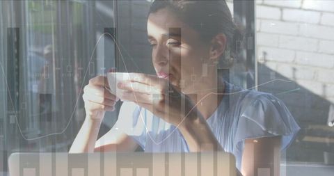 Businesswoman Analyzing Data While Drinking Coffee in Modern Office