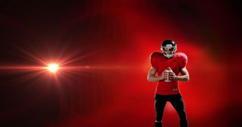 American Football Player Posing Against Vibrant Red Background
