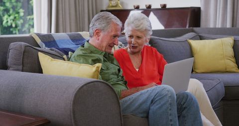 Senior Couple Relaxes with Laptop in Cozy Living Room - Download Free Stock Images Pikwizard.com