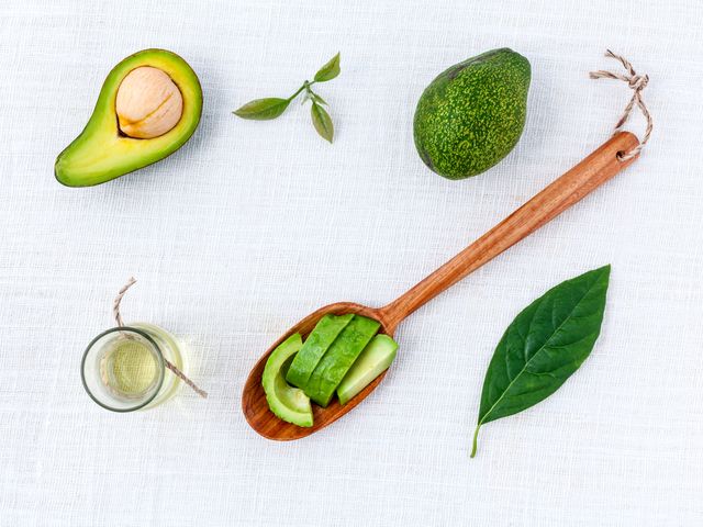 Flat Lay of Avocado Slices and Oil with Leaves on White Background - Download Free Stock Photos Pikwizard.com