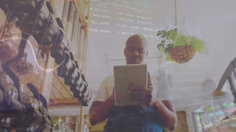African American Shop Owner Analyzing Financial Data on Tablet