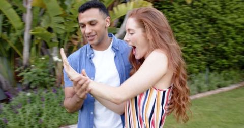 Happy couple celebrating engagement outdoors