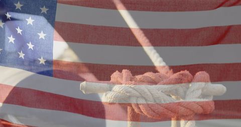 Waving american flag and tied rope symbolizing unity