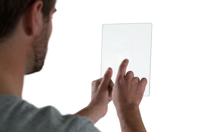 Man using glass digital tablet against white background