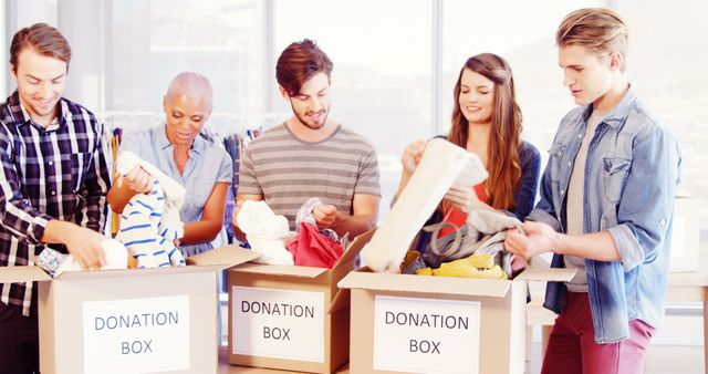 Volunteers Sorting Donation Boxes and Charitable Apparel Contributions - Download Free Stock Images Pikwizard.com