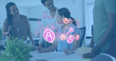 Women collaborating over holographic network and blueprints in modern office technology