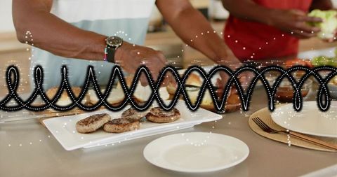 Two men assembling burger patties on buns in modern kitchen with dotted light overlay
