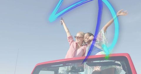 Two Friends Celebrating Adventure in Open Convertible
