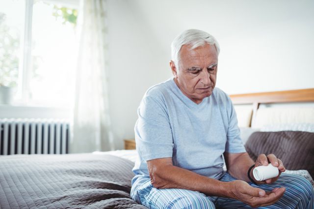 Senior Man Taking Medicines in Bedroom - Download Free Stock Photos Pikwizard.com
