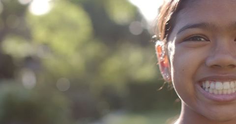 Close-up Portrait of Joyful Girl Enjoying Sunny Outdoor Day
