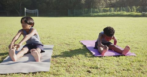 Children Practicing Outdoor Yoga on Sunny Day on Grassy Field