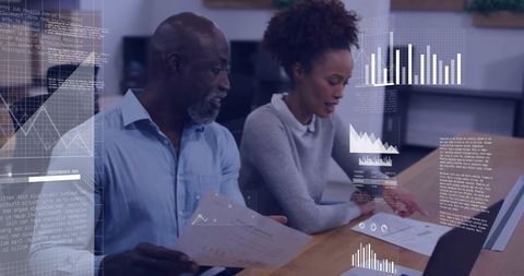 Diverse business colleagues analyzing data reports together