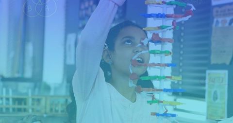 Girl Engaging with DNA Model in Science Classroom
