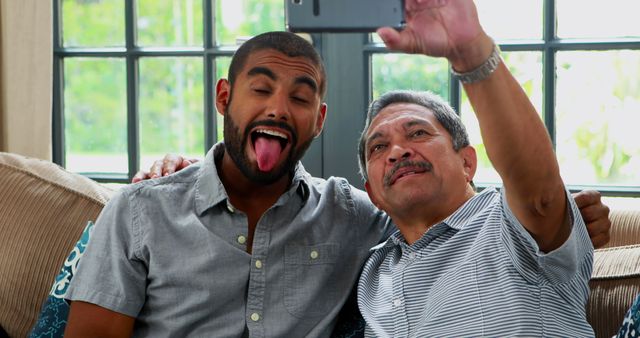 Father and Son Taking Selfie Having Fun on Couch - Download Free Stock Images Pikwizard.com