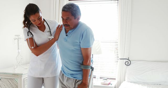 Nurse Assisting Elderly Man with Crutches for Home Care - Download Free Stock Images Pikwizard.com