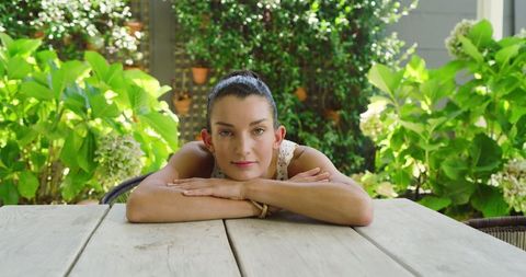 Mid adult woman relaxing on rustic garden patio tranquility