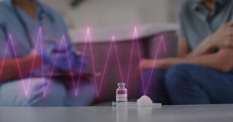 Cardiograph Over Doctor and Patient Discussing COVID-19 Vaccine