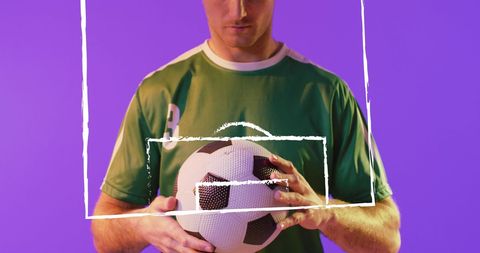 Soccer Player Holding Ball Over Digital Purple Background - Download Free Stock Images Pikwizard.com