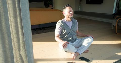 Peaceful Meditation Indoors in Sunlit Bedroom