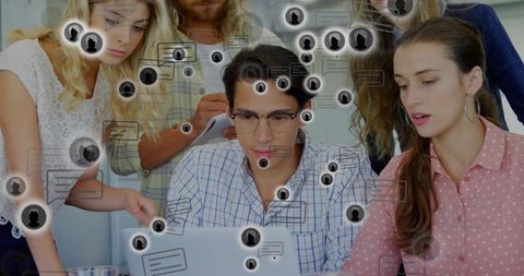 Team collaborating around laptop with social media network overlay for digital marketing