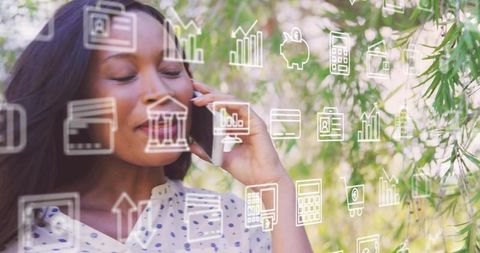 Black woman talking on mobile in park with floating finance and data icons overlay