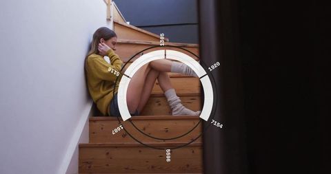 Pensive woman on wooden staircase with data technology overlay