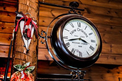 Vintage paddle steamer clock hanging on rustic wooden wall