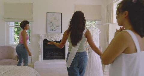 Bride-To-Be Choosing Wedding Dress with Friends in Bright Room