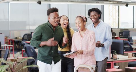 Joyful Colleagues Celebrating Success in Office Setting