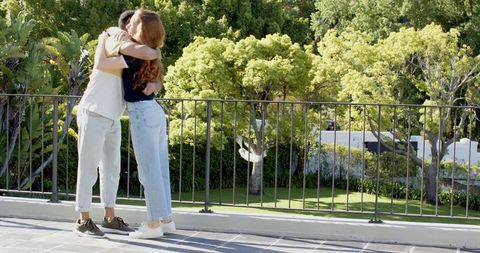 Couple Embracing with Joyful Father Announcing Baby News