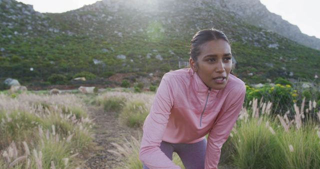 Determined Female Runner in Pink Jacket Resting During Outdoor Workout - Download Free Stock Images Pikwizard.com