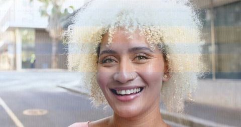 Smiling Woman Embracing Urban Street Style in Pink Casual Top