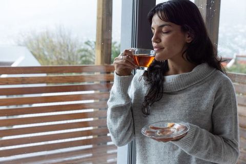Woman Drinking Tea Enjoying Peaceful Morning by Window
